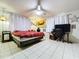 Well-lit bedroom features tile flooring, a ceiling fan, and comfortable furnishing at 4966 Foxrun Ln, Lakeland, FL 33813