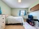Cozy bedroom with a comfortable bed, dresser, and a mounted TV; perfect for relaxing at 4966 Foxrun Ln, Lakeland, FL 33813