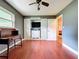 Bright bedroom offers a closet, a window, wood floors and a ceiling fan at 4966 Foxrun Ln, Lakeland, FL 33813