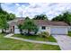 Charming single-story home with lush landscaping and attached two-car garage at 4966 Foxrun Ln, Lakeland, FL 33813