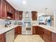 Updated kitchen features stainless steel appliances, tile backsplash, and wood cabinets at 4966 Foxrun Ln, Lakeland, FL 33813
