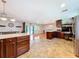 Open kitchen flows into dining and living areas, featuring an island, and stainless steel appliances at 4966 Foxrun Ln, Lakeland, FL 33813