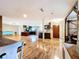 Open concept layout with hardwood floors connecting kitchen, dining, and living spaces at 4966 Foxrun Ln, Lakeland, FL 33813