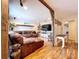 Inviting living room with leather sectional, mounted TV, wood shelves, and coastal-themed decorations at 4966 Foxrun Ln, Lakeland, FL 33813
