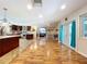 Spacious open floor plan with wood flooring, kitchen with island, and living room with comfortable seating area at 4966 Foxrun Ln, Lakeland, FL 33813