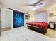 Comfortable main bedroom with tiled floors, ceiling fan, sliding barn door and closet space at 4966 Foxrun Ln, Lakeland, FL 33813