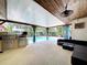 Outdoor patio featuring a built-in grill, mini fridge, and comfortable seating near the pool at 4966 Foxrun Ln, Lakeland, FL 33813