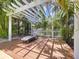 Inviting wooden pergola with lounge seating in a tropical backyard at 4966 Foxrun Ln, Lakeland, FL 33813