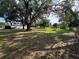 Expansive backyard with mature trees offering ample shade, showcasing the property's outdoor space at 5138 Rock Dove Trl, Lakeland, FL 33810