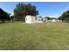 Charming mobile home with a well-maintained lawn and mature tree at 5138 Rock Dove Trl, Lakeland, FL 33810