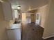 Modern kitchen with white cabinets, stainless steel sink, and wood grain flooring at 5138 Rock Dove Trl, Lakeland, FL 33810