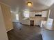 Bright kitchen with white cabinetry, marble countertops, and wood grain flooring at 5138 Rock Dove Trl, Lakeland, FL 33810