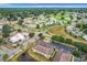 Aerial view of the residential area with houses, green spaces, roadways and a golf course in the background at 519 Sandstone St, Lakeland, FL 33809