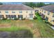 Overhead view of residential buildings, showing well-kept yards, screen porches, and an inviting pond at 519 Sandstone St, Lakeland, FL 33809