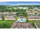 Aerial view of a pool and the surrounding community and landscaping at 519 Sandstone St, Lakeland, FL 33809