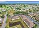Overhead view of a residential area, showing buildings with parking, lush greenery, and a serene pond at 519 Sandstone St, Lakeland, FL 33809