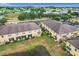 Aerial view of a residential complex with manicured landscaping, parking areas, and nearby green spaces at 519 Sandstone St, Lakeland, FL 33809