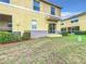 The home's backyard features a lush lawn, trimmed shrubs, and a patio sliding door accessing a relaxing screened space at 519 Sandstone St, Lakeland, FL 33809