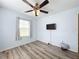 Bedroom features wood-look floors, a ceiling fan, and soft blue walls at 519 Sandstone St, Lakeland, FL 33809