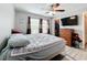 Bedroom features a ceiling fan, tv, and a closet at 519 Sandstone St, Lakeland, FL 33809