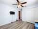 Bedroom features wood-look floors, a ceiling fan, and a closet at 519 Sandstone St, Lakeland, FL 33809