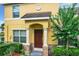 Inviting home entrance featuring a covered porch with decorative columns and a well-manicured garden at 519 Sandstone St, Lakeland, FL 33809