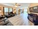 Spacious living room with wood-look floors, comfortable seating, and a view of the backyard at 519 Sandstone St, Lakeland, FL 33809