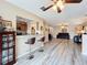 Open-concept living area with wood-look floors, modern furniture, and bar seating to the kitchen at 519 Sandstone St, Lakeland, FL 33809