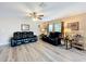 Bright and airy living room featuring wood-look floors, comfortable seating, and windows at 519 Sandstone St, Lakeland, FL 33809