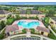 Aerial view of a community pool surrounded by lush landscaping and multiple lounge chairs at 519 Sandstone St, Lakeland, FL 33809