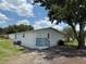 Back exterior of home, showing small back porch with light blue stairs, and a fenced yard at 5217 Turtle Dove Trl, Lakeland, FL 33810