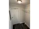 Small closet with light walls, dark hardwood floor, wire shelf, and a white door at 5217 Turtle Dove Trl, Lakeland, FL 33810