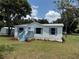 Charming home with a light blue painted porch, matching shutters, a well-maintained lawn, and a metal roof at 5217 Turtle Dove Trl, Lakeland, FL 33810