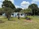Lovely home with a fenced yard, well-maintained lawn, light blue painted porch, and matching shutters at 5217 Turtle Dove Trl, Lakeland, FL 33810