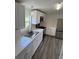 Bright kitchen featuring white cabinets, stainless steel appliances, a stainless sink, and modern countertops at 5217 Turtle Dove Trl, Lakeland, FL 33810