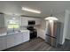 The modern kitchen is equipped with stainless steel appliances, sleek countertops, and bright lighting at 5217 Turtle Dove Trl, Lakeland, FL 33810