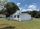 Charming home with a light blue painted porch, matching shutters, a well-maintained lawn, and a metal roof at 5217 Turtle Dove Trl, Lakeland, FL 33810