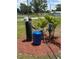 Water softener system with multiple tanks installed outdoors in a mulch bed surrounded by palm trees at 5217 Turtle Dove Trl, Lakeland, FL 33810