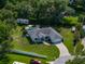 Aerial view of a well-maintained property featuring lush landscaping, a pool, and a long driveway at 5427 Orange Valley Dr, Lakeland, FL 33813