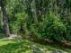 Scenic backyard featuring lush greenery, a water feature, and ample space for outdoor enjoyment at 5427 Orange Valley Dr, Lakeland, FL 33813