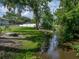 Spacious backyard with a creek and a seating area, perfect for enjoying nature and outdoor living at 5427 Orange Valley Dr, Lakeland, FL 33813