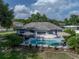 Aerial view of a private backyard featuring a refreshing pool, patio with seating, and beautifully landscaped surroundings at 5427 Orange Valley Dr, Lakeland, FL 33813