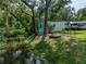 Expansive backyard featuring a water feature, shed, RV, and ample space for outdoor activities at 5427 Orange Valley Dr, Lakeland, FL 33813