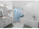Clean bathroom featuring dual sinks, shower, garden tub, and bright lighting at 5427 Orange Valley Dr, Lakeland, FL 33813