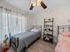 Cozy bedroom features a twin bed, modern ceiling fan, and ample natural light at 5427 Orange Valley Dr, Lakeland, FL 33813