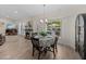 Cozy dining area with a fireplace, view of the pool, and seamlessly blends indoor and outdoor living at 5427 Orange Valley Dr, Lakeland, FL 33813