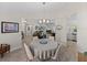 Spacious dining area with modern lighting, white chairs, open concept design, and inviting decor at 5427 Orange Valley Dr, Lakeland, FL 33813