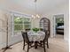 Bright dining area featuring a large window, wood floors, modern lighting, and neutral tones at 5427 Orange Valley Dr, Lakeland, FL 33813