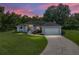 Charming single-story home with a gray exterior, well-manicured lawn, and an attached two-car garage at 5427 Orange Valley Dr, Lakeland, FL 33813