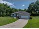 Beautiful single-story home with a well-maintained lawn, a covered porch, and a spacious two-car garage at 5427 Orange Valley Dr, Lakeland, FL 33813